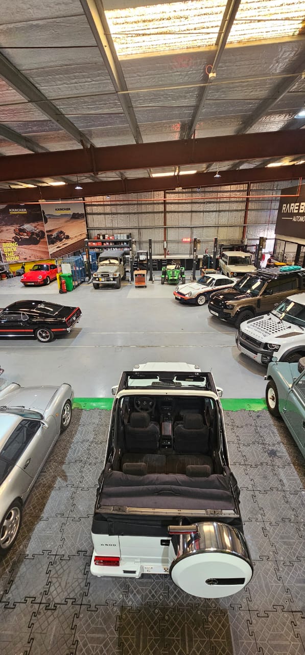 Aerial view of the DW Octane workshop floor with classic and performance cars